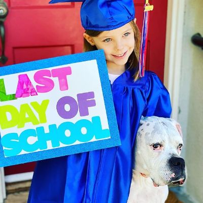 Picture of Kristen Storm's daughter Harper Rose Barash and her dog during Harper's kinder garden graduation